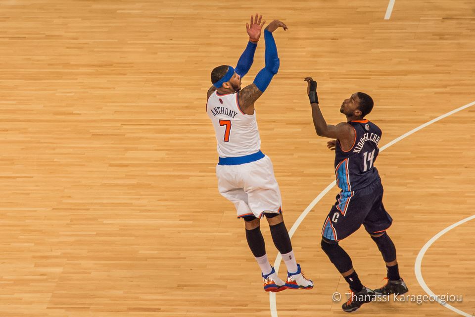 Carmelo Anthony hits one of his 6 3-pointers over Michael Kidd-Gilchrist and scores a career high, franchise high and MSG high 62 points. New York Knicks vs. Charlotte Bobcats. January 24th, 2014. Madison Square Garden, New York. www.thanassikarageorgiou.com  ©Thanassi Karageorgiou